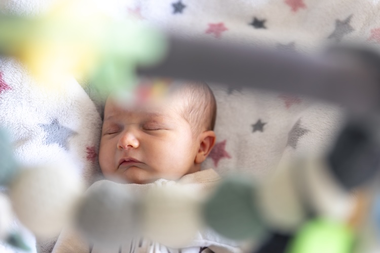 Newborn Baby Sleep. Girl Infant Sleep Lies In Child Bed.